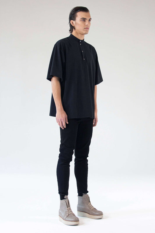 Model wearing shirt Holy in black, side angle showcasing stand collar