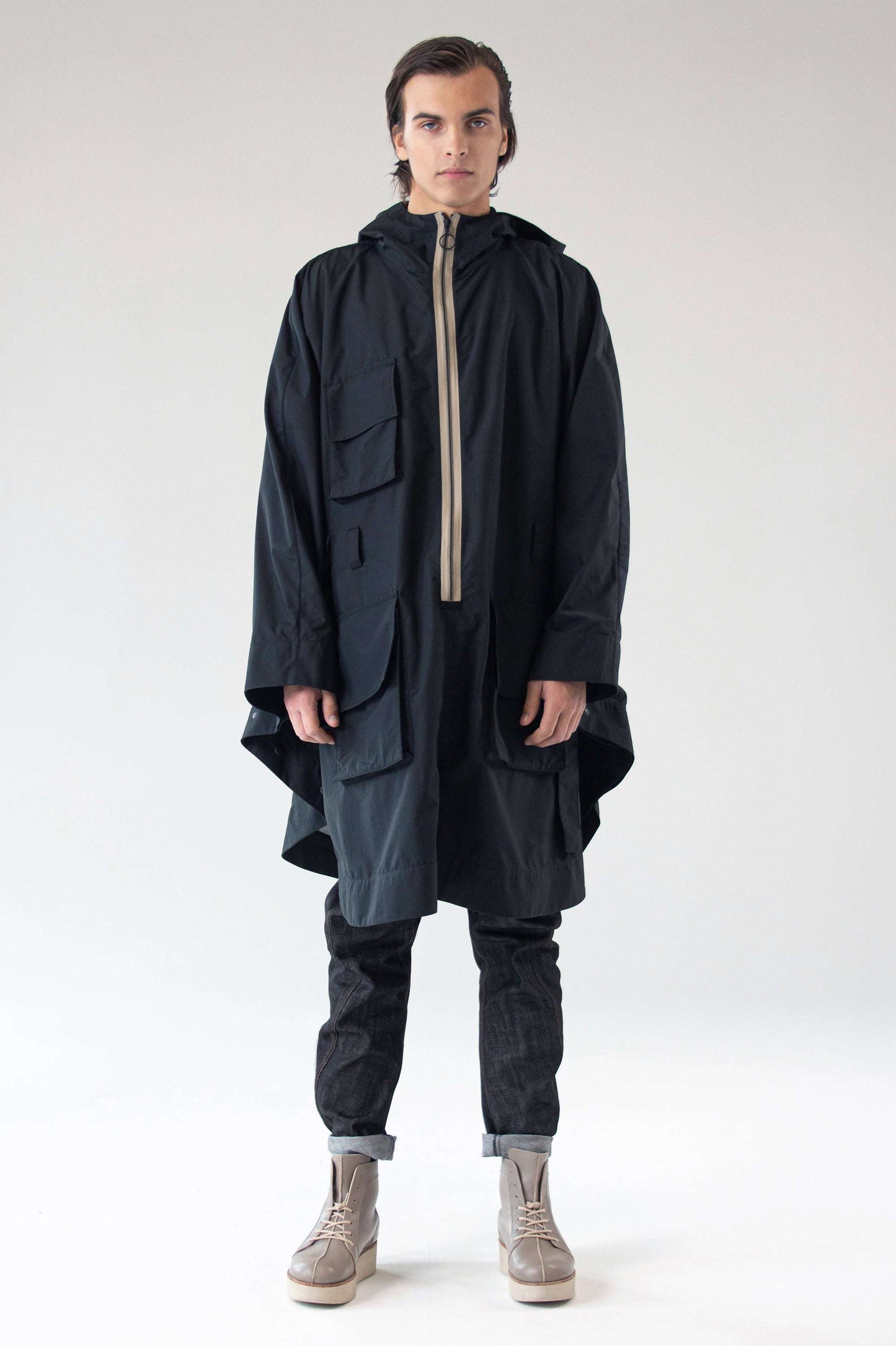 Unisex waterproof Poncho SEEKER by One Wolf, full-length front view on male model.